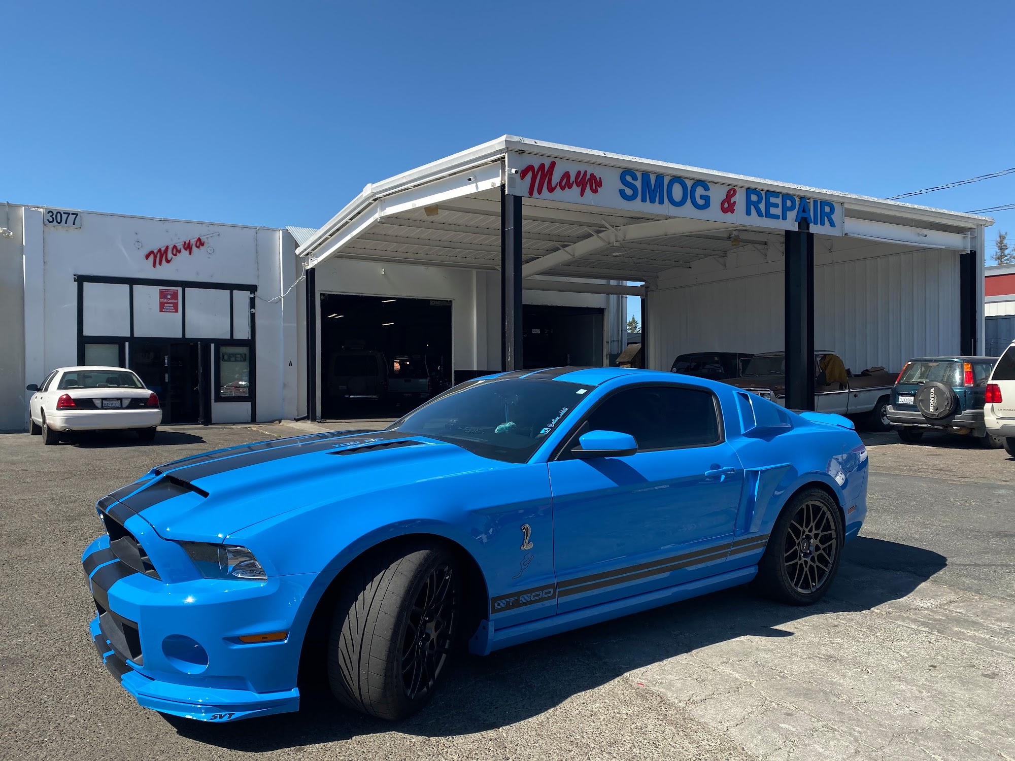Maya Smog and Repair shop with a blue vehicle outside