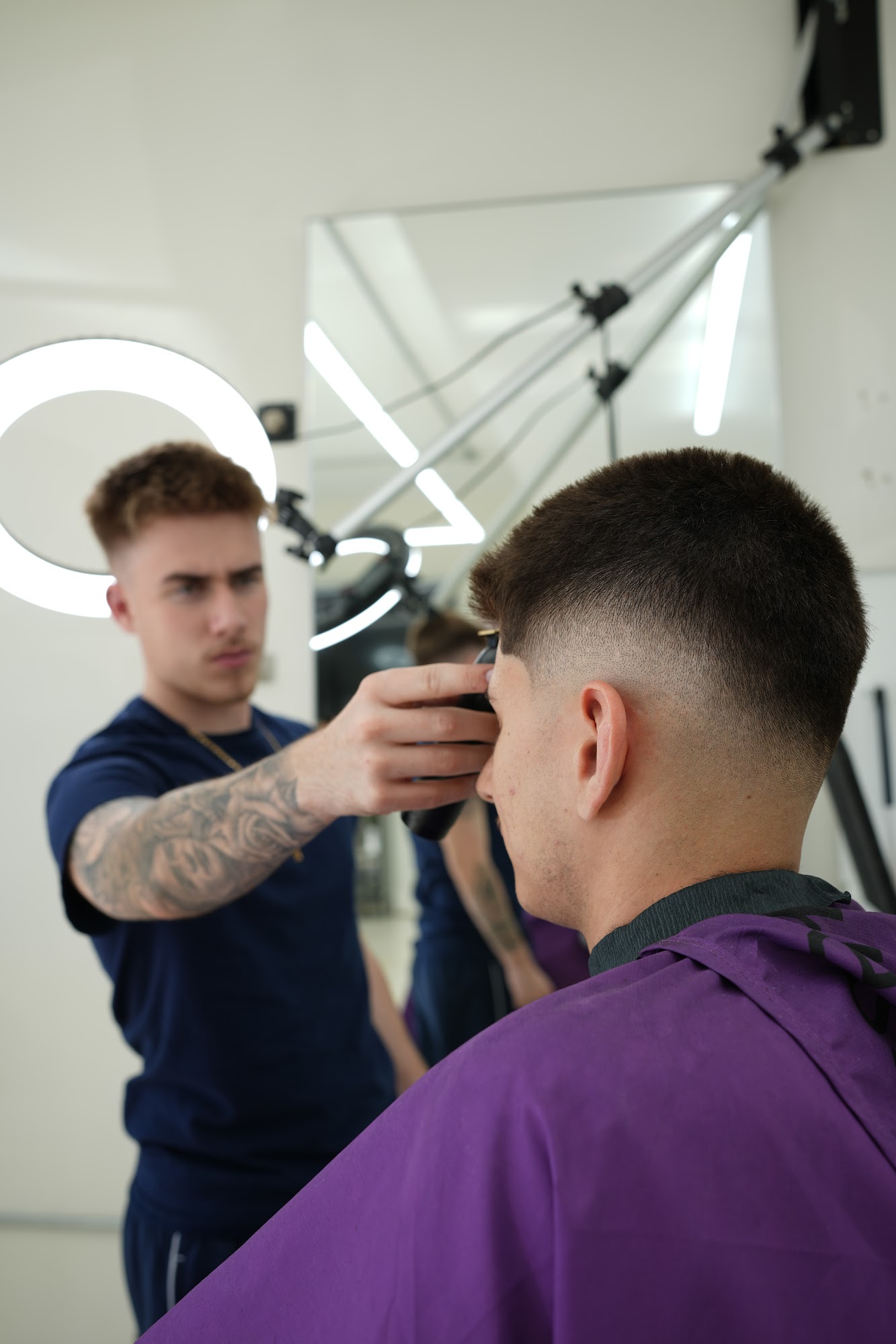Culture barber performing a haircut in the actual shop.
