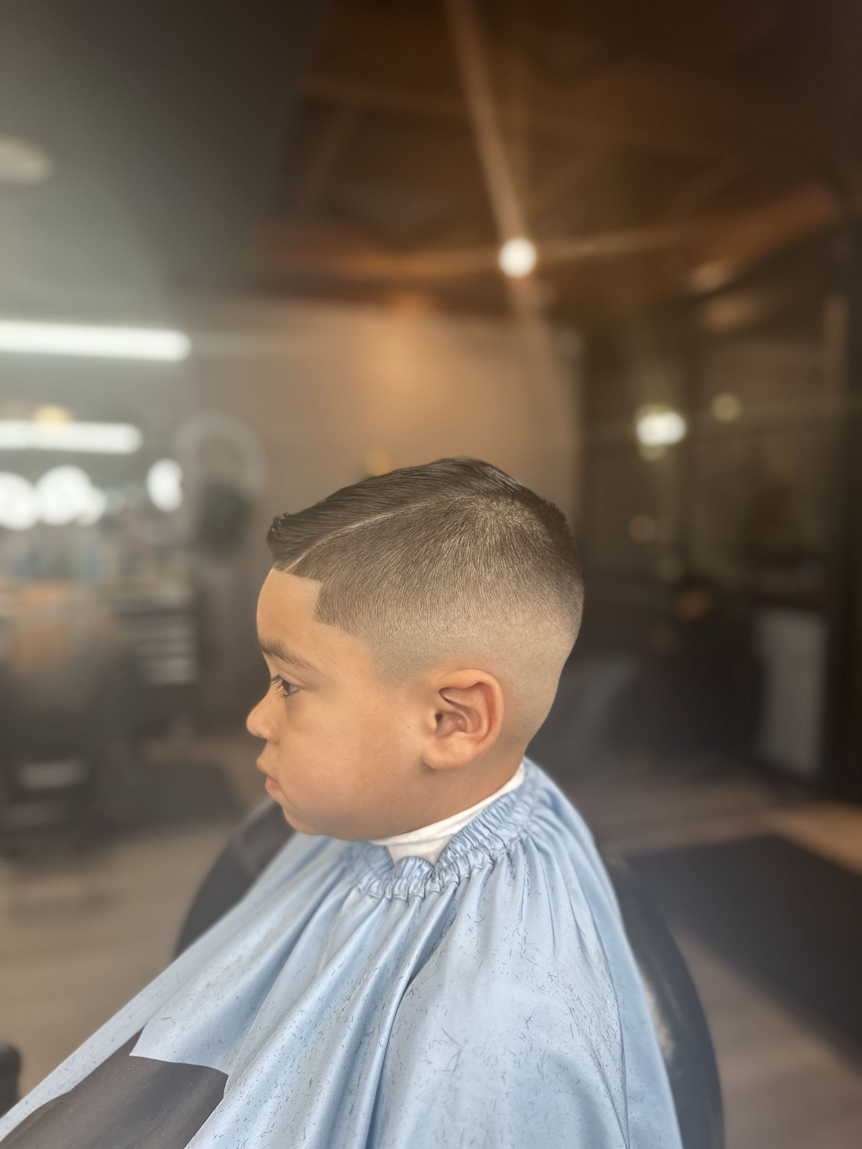 Younger client with a crisp short taper, from the same verified Booksy work gallery